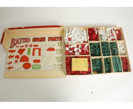 An original Bayko circa 1948 Spare Parts Cabinet, in red with four trays, each contain various spare parts, bottom shelf is  