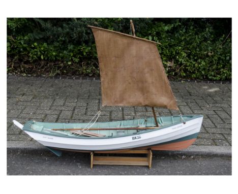 A large scale model of Holy Island Sailing Boat 'Three Sisters' constructed in wood with one mast and sail, finished in white