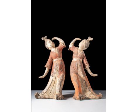 Tang Dynasty, Ca. AD 618-907.
A pair of dancing ladies. The figures are dressed in long skirts, with a midi overcoat, and the