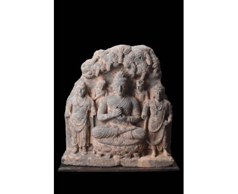 Ca. AD 200 - 300.
A schist relief panel with the seated Buddha attended by Brahma and Indra, as well as two Bodhisattvas. It 