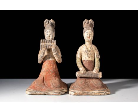 Tang Dynasty, Ca. AD 618-907.
A pair of terracotta female musicians. The figures are dressed in long dresses with a short-sle