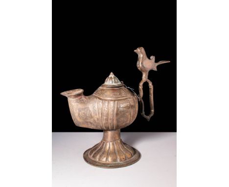 Ca. AD 1100 - 1300.
A copper-alloy oil lamp with a bird-shaped handle terminal and an attractive green patina. The lamp stand