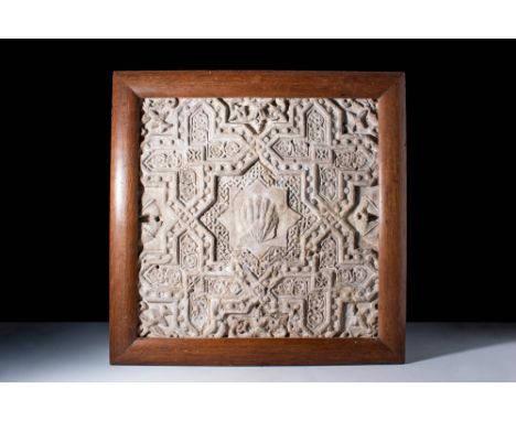 .
A geometric earthenware tile panel of square form, consisting of an interlocking star-shaped geometric design carved in dee