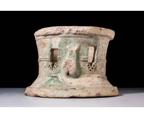 An unglazed earthenware circular chalice, or food warmer with the remains of a green glaze to one side and two small pierced 