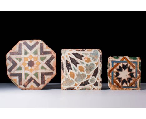 Ca. 15th - 16th century AD.A set of three glazed arista ceramic tiles of square form, each with interlocking geometric design