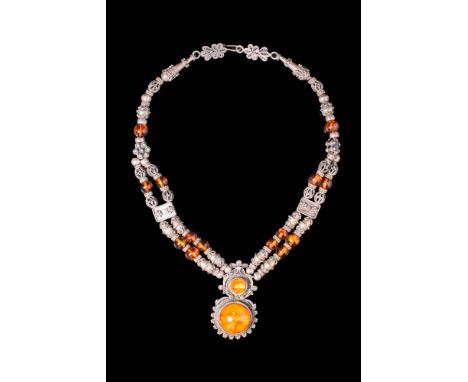 Ca. 18th - 19th century AD.
A silver braided wheat amber pendant necklace. The main amber cabochon is set within a detailed s