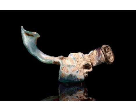 Ca. AD 600 - 900.A glass flask crafted in the shape of a fish using a mould. The vessel's exterior is adorned with blue glass