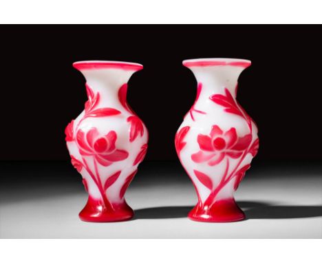 Ca. 19th century AD.
A pair of white ground red overlay Peking glass vases in baluster form. Glass production in China reache