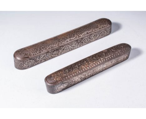 Ca. AD 1880 - 1900.
A pair of of round-ended rectangular formed pen cases. The vertical sides and top inlaid in silver with a