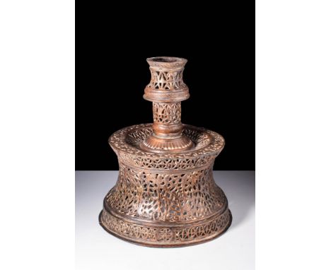 Ca. AD 1300 - 1500.A bronze candlestick with a traditional form, featuring a truncated conical base. The shoulder is designed