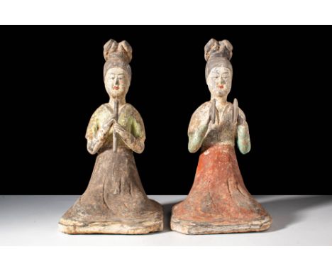 Tang Dynasty, Ca. AD 618-907.
A pair of terracotta female musicians. The figures are dressed in long dresses with a short-sle