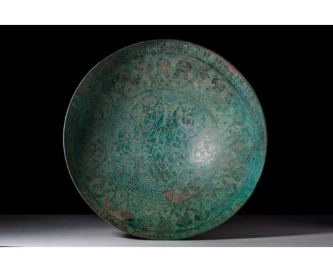 Ca. AD 1200.
A superb bronze bowl of circular form and extra-large size with elaborate Kufic calligraphy and engraved details