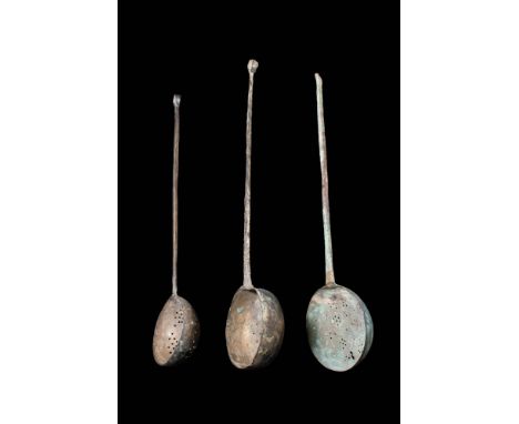 Ca. AD 1100 - 1200.
A set of three bronze strainer ladles with its form both elegant and practical. Each features a round bow