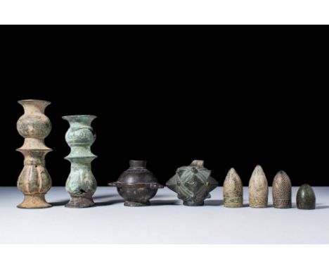 Ca. 12-13th century .A collection of four Islamic thimbles incised with a dotted design, two bronze candlestick necks, both o