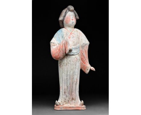 Tang Dynasty, Ca. AD 618-907.
A terracotta court lady. She is depicted standing upright, wearing a short-sleeved long dress w