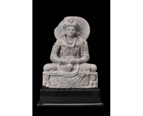 Ca. AD 200 - 300.
A Gandharan schist, depicting the seated figure of Maitreya, exuding an aura of profound spirituality and g