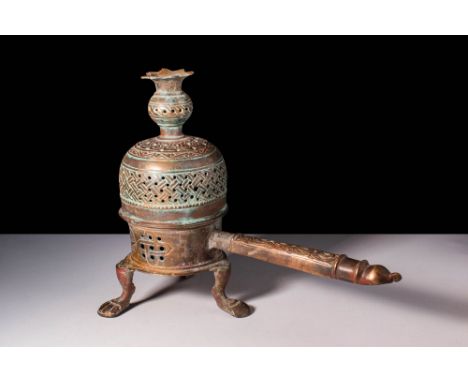 Ca. AD 1200 - 1300.
A bronze censer with a cylindrical base supported by three feet. The censer features a domed hinged lid w