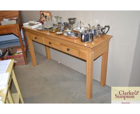 An oak console table fitted three drawers