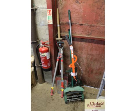 A quantity of gardening tools to include spades; shovels; rakes, a lopper etc