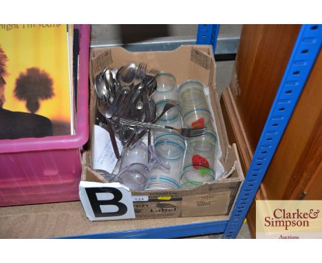 A box containing stainless steel cutlery, plastic cups etc.