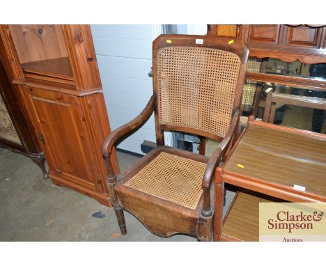 A Victorian commode chair with wicker panels