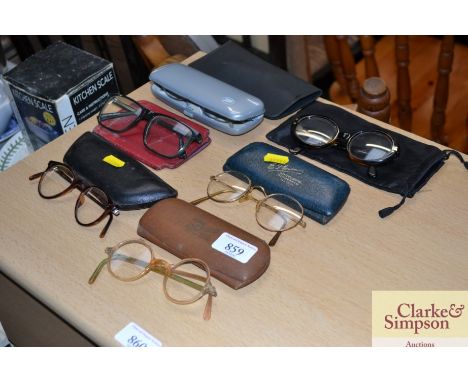 A collection of various vintage spectacles and cases 