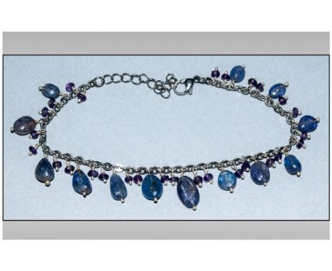 Tanzanite and Amethyst Charm Bracelet, polished ovoid tanzanites and small faceted amethysts suspended from a belcher chain b