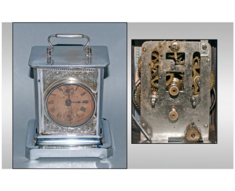 A Late 19th Century Silvered Metal Carriage Clock with a paper dial with two winding points to the back. Incorporated with a 