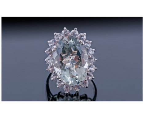 Green Amethyst and White Topaz Cocktail Ring, a large oval cut green amethyst of 11.5cts, set in a frame of round cut white t