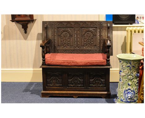 Carved Oak Lift Up Top Marks Bench with a Lift up Seat Below Three Carved Panels Supported by Turned Spindle Arms, with The B