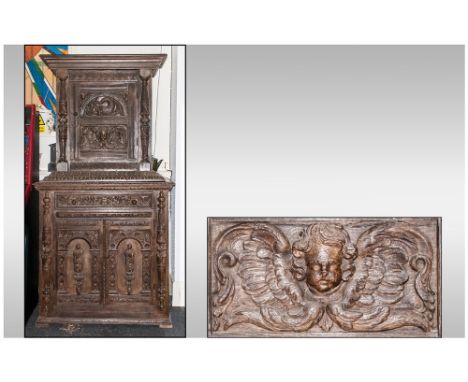 A Dutch Flemish Carved Oak Cabinet on cupboard base, profusely decorated with elements of earlier carving applied of figures 