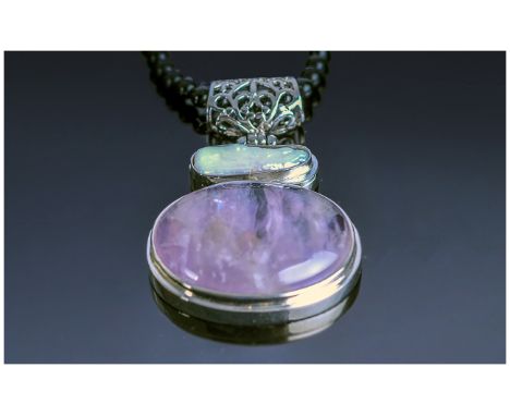 Amethyst, White Keshi Pearl and Black Agate Necklace, a large cabochon amethyst below a white Keshi pearl, both bezel set, wi
