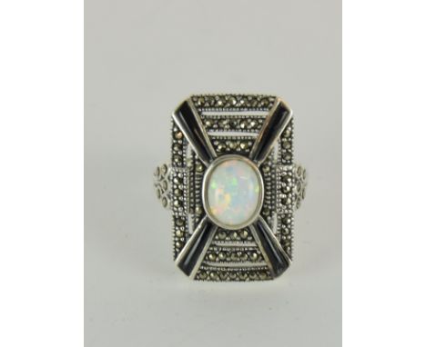 a silver art deco style ring inset with onyx and large central opal