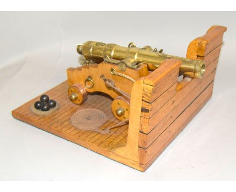 An impressive 18th century model of a deck mounted ships cannon with a barrel length of 23.5 cms and a deck size of 27cms by 