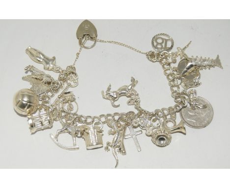 Silver charm bracelet and 19 charms
