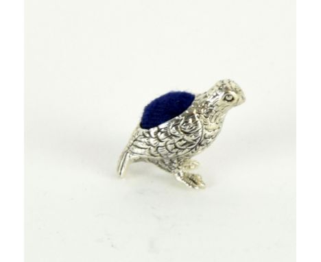 a silver partridge pincushion