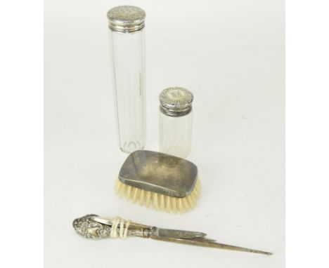 Silver brush ,two silver topped bottles a silver handled button pull