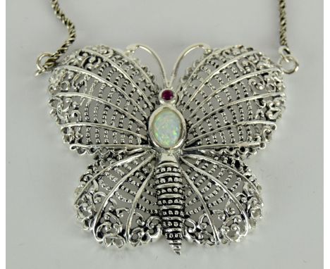 a substantial silver butterfly necklace inset with opal and garnet