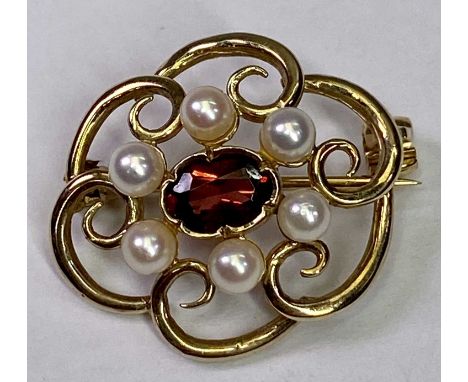 ANTIQUE 9CT GOLD OPENWORK BROOCH - with centrally mounted garnet and seed pearl surround, 22 x 19mm, 3.2grms