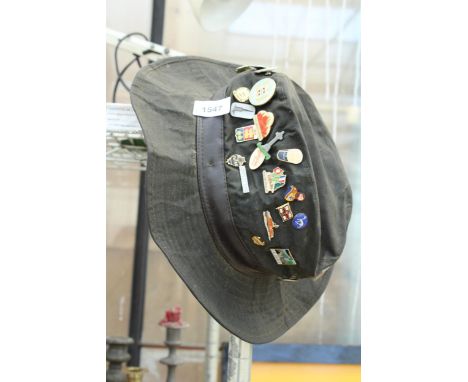 A HAT CONTAINING A LARGE QUANTITY OF ASSORTED ENAMEL PIN BADGES 