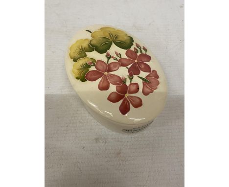 AN OVAL MOORCROFT LIDDED TRINKET BOX - PINK GERANIUM 