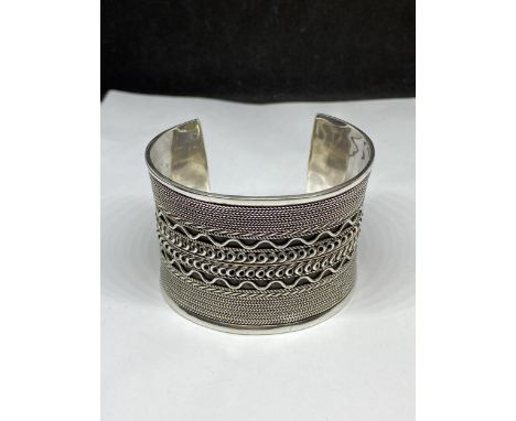 A MARKED SILVER HEAVY WIDE CUFF BANGLE HEIGHT 5CM AND WIDTH 7CM GROSS WEIGHT 92 GRAMS 