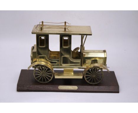 A SOLID BRASS TAXI MODEL ON A WOODEN PLINTH 