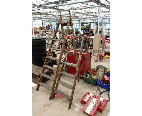TWO VINTAGE WOODEN STEP LADDERS TO INCLUDE A FOUR RUNG AND A SEVEN RUNG 