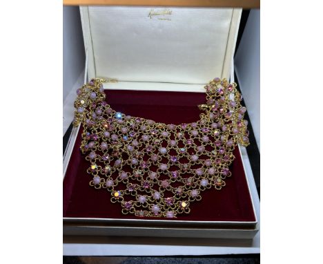 A DECORATIVE BIB CHOKER NECKLACE WITH PINK STONES IN A PRESENTATION BOX 