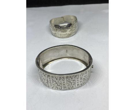 TWO MARKED SILVER BANGLES ONE 1884 BY REGINALD WALTER HEWETT AND A BABY WRAP BANGLE 