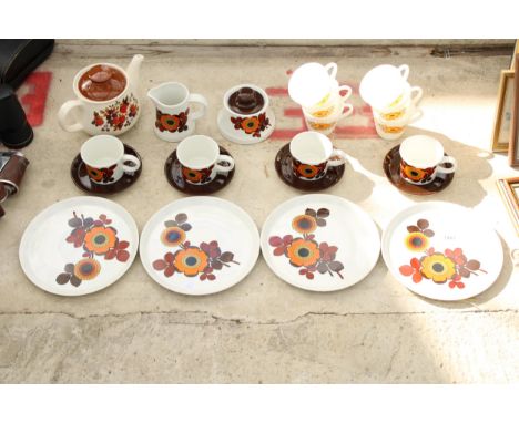 AN ASSORTMENT OF RETRO CERAMIC DINNER WARE ITEMS TO INCLUDE CUPS AND SAUCERS, A TEAPOT AND A MILK JUG ETC