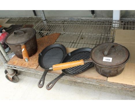 TWO CAST IRON SKILLET PANS AND TWO FURTHER CAST IRON PANS WITH WOODEN HANDLES 