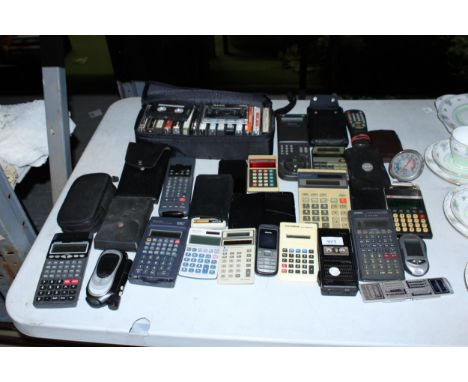 A LARGE COLLECTION OF VINTAGE CALCULATORS, PLUS MOBILE PHONES, A DICTAPHONE, ETC