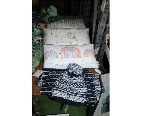 FOUR AS NEW ITEMS WITH TAGS TO INCLUDE THREE CUSHIONS AND A HAT AND SCARF SET 